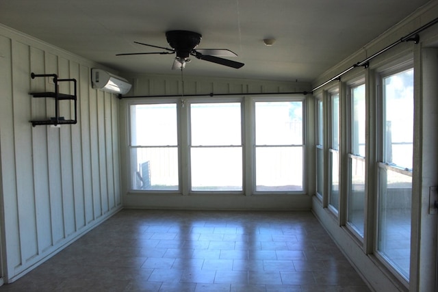 unfurnished sunroom with a wall unit AC, ceiling fan, and lofted ceiling