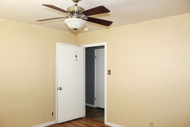 unfurnished room featuring dark hardwood / wood-style floors and ceiling fan