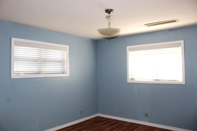 spare room with dark hardwood / wood-style floors