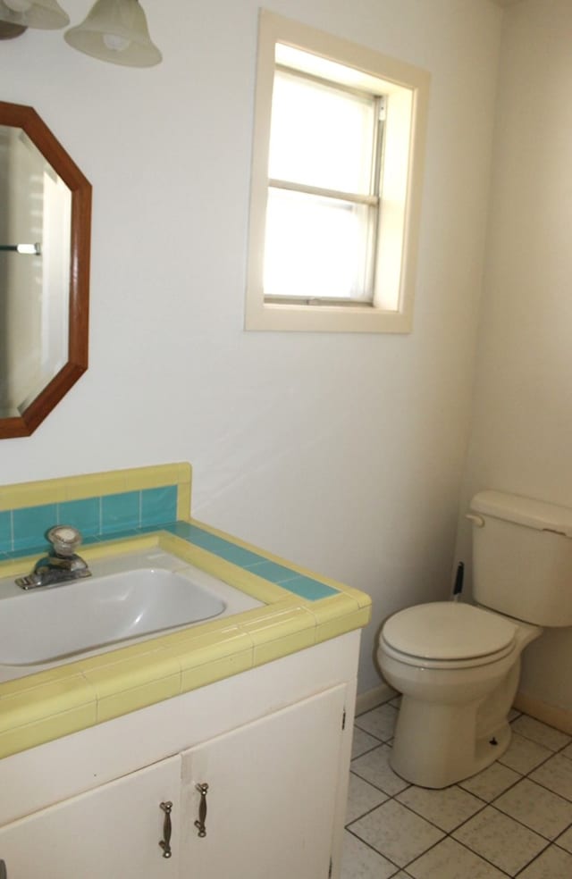 bathroom featuring toilet, vanity, and tile patterned floors