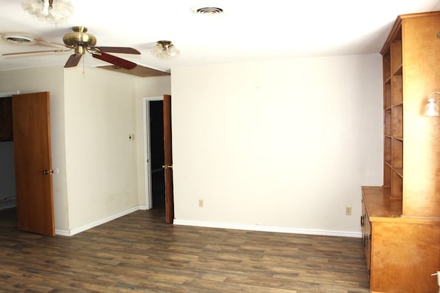 unfurnished living room featuring dark hardwood / wood-style flooring and ceiling fan