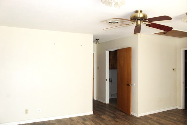 empty room with ceiling fan and dark wood-type flooring