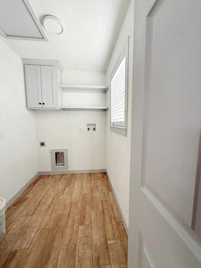 laundry area featuring electric dryer hookup, cabinets, washer hookup, and light hardwood / wood-style floors