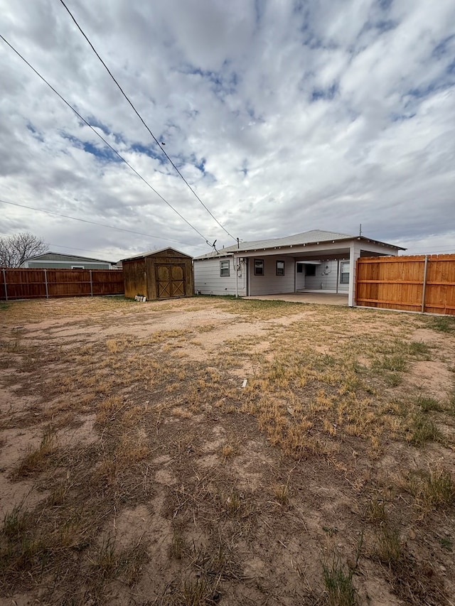 back of house featuring a shed and a patio