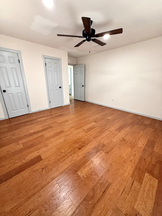 unfurnished bedroom with ceiling fan and light hardwood / wood-style flooring