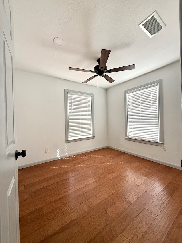 empty room featuring ceiling fan and wood-type flooring