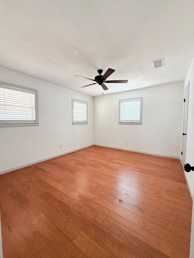 empty room featuring ceiling fan and light hardwood / wood-style flooring