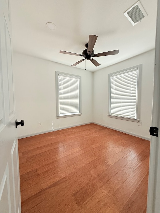 unfurnished room featuring light wood-type flooring and ceiling fan