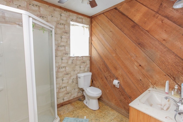 1004 E 15th St, Big Spring, TX 79720 - bathroom with a stall shower, toilet, ceiling fan, baseboards, and vanity