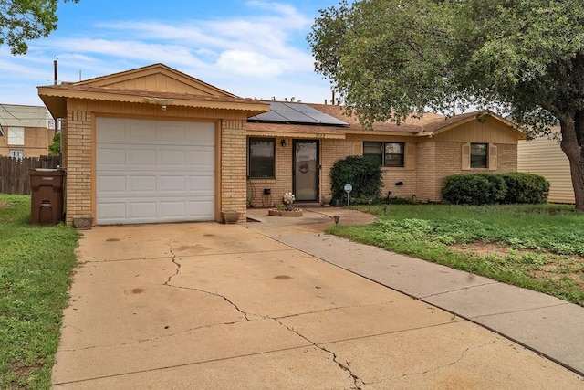 2108 Cecilia, Big Spring, TX 79720 - single story home featuring brick siding, roof mounted solar panels, a garage, and driveway