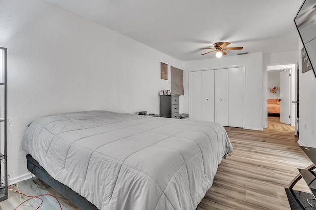 2108 Cecilia, Big Spring, TX 79720 - bedroom featuring wood finished floors, a closet, a ceiling fan, and connected bathroom