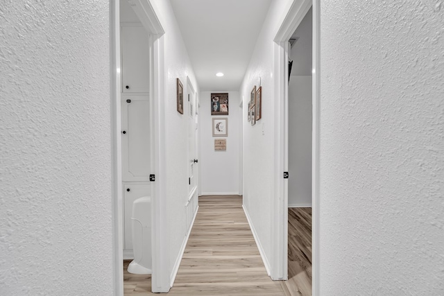 2108 Cecilia, Big Spring, TX 79720 - hall with a textured wall, recessed lighting, and light wood-style flooring