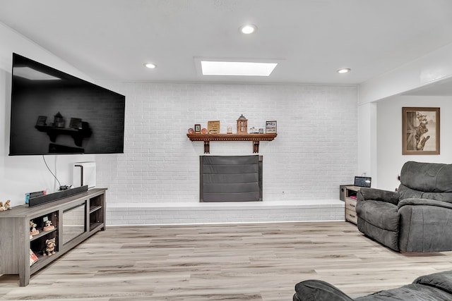 2108 Cecilia, Big Spring, TX 79720 - living room featuring brick wall, a skylight, wood finished floors, and recessed lighting