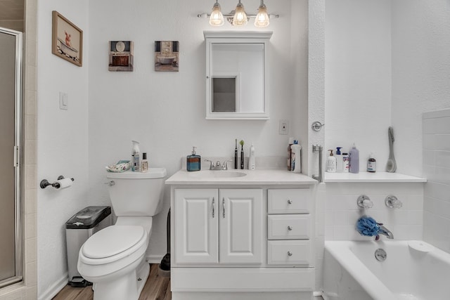 2108 Cecilia, Big Spring, TX 79720 - bathroom with vanity, a stall shower, a bath, and wood finished floors