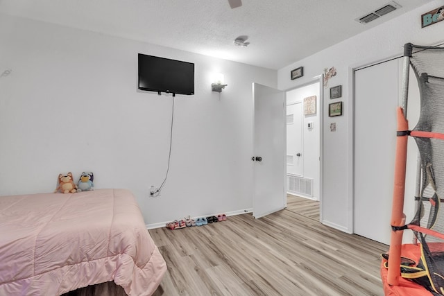 2108 Cecilia, Big Spring, TX 79720 - bedroom featuring light wood finished floors and a textured ceiling
