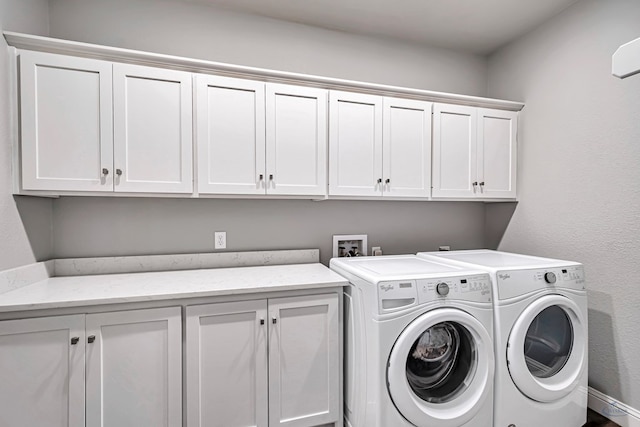 laundry room featuring cabinets and separate washer and dryer