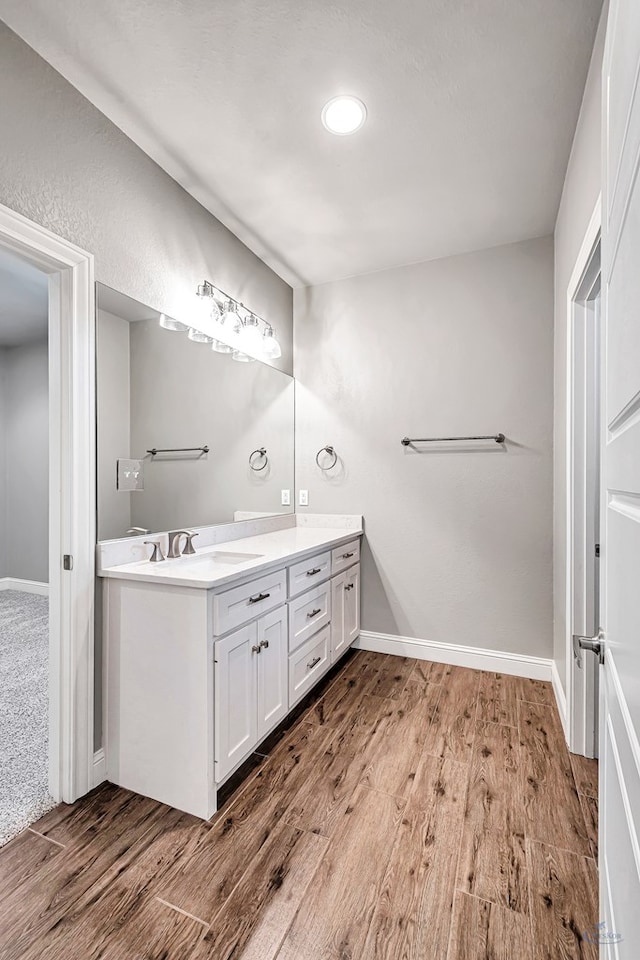 bathroom with hardwood / wood-style flooring and vanity