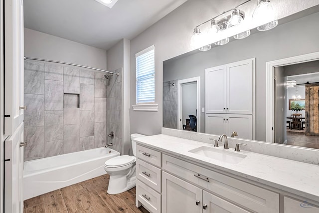 full bathroom with toilet, vanity, and tiled shower / bath