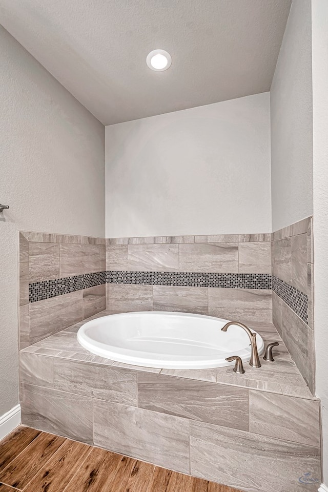 bathroom with tiled bath