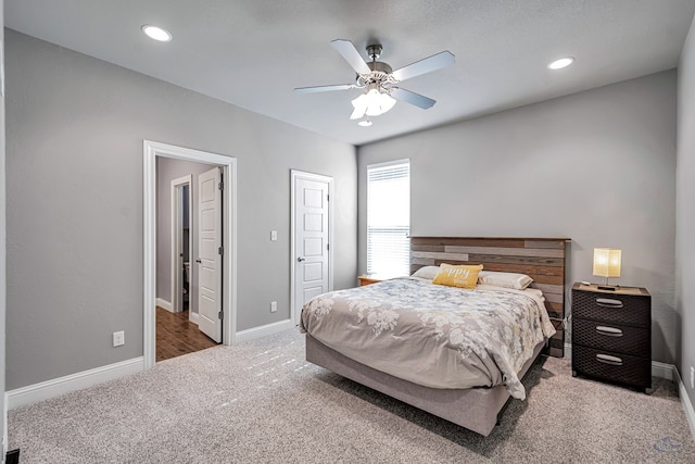 bedroom featuring ceiling fan and dark carpet