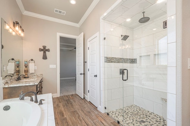 full bath with a stall shower, wood tiled floor, a bath, and crown molding