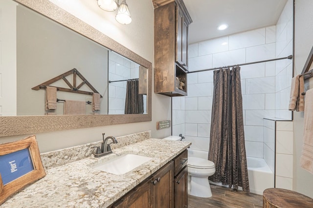 bathroom featuring toilet, vanity, shower / bath combo with shower curtain, and wood finish floors