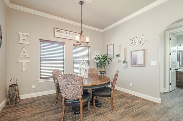 dining area with arched walkways, a notable chandelier, dark wood finished floors, ornamental molding, and baseboards