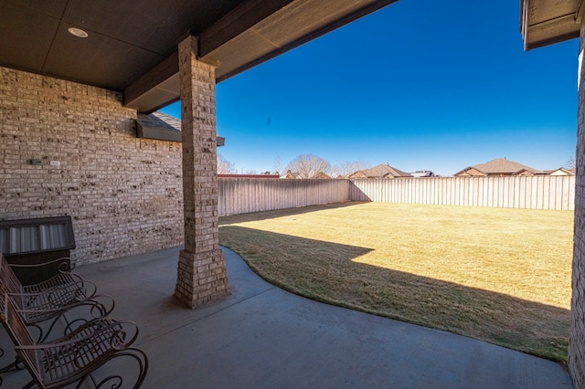 view of yard with a fenced backyard and a patio