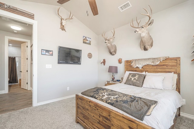 bedroom featuring carpet floors, a ceiling fan, visible vents, vaulted ceiling, and baseboards