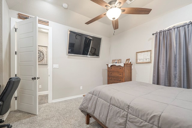 bedroom featuring light carpet, baseboards, and a ceiling fan