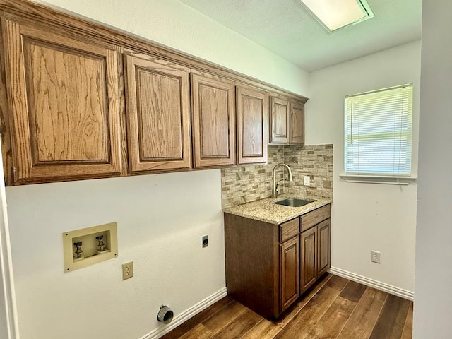 3612 Oakridge Dr, Midland, TX 79707 - laundry area with cabinet space, washer hookup, electric dryer hookup, and dark wood-style flooring