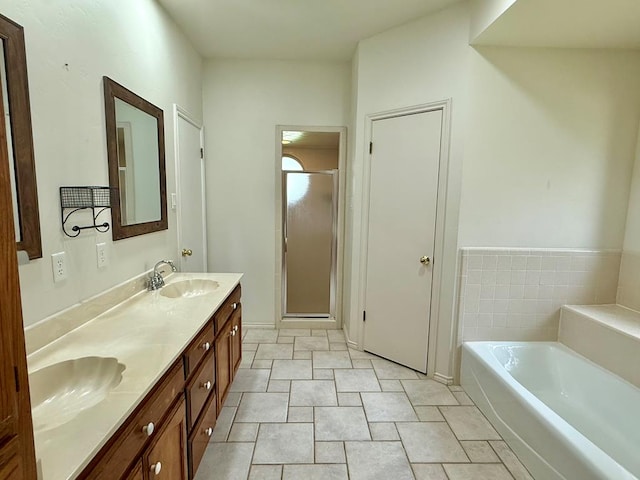 3612 Oakridge Dr, Midland, TX 79707 - full bathroom featuring double vanity, a garden tub, and a shower stall