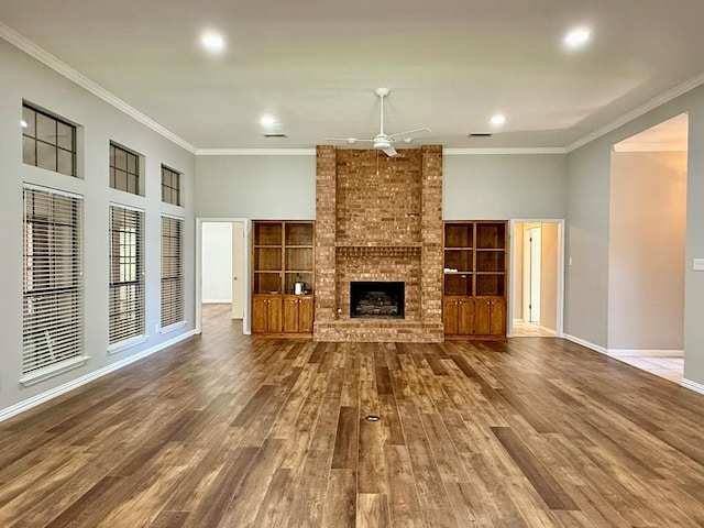 3612 Oakridge Dr, Midland, TX 79707 - unfurnished living room with a ceiling fan, ornamental molding, wood finished floors, a brick fireplace, and recessed lighting