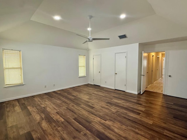 3612 Oakridge Dr, Midland, TX 79707 - unfurnished bedroom featuring vaulted ceiling, dark wood-type flooring, ceiling fan, and multiple closets