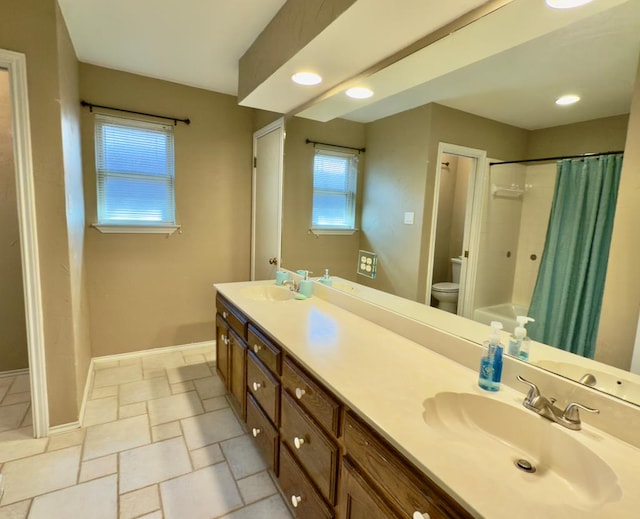 3612 Oakridge Dr, Midland, TX 79707 - bathroom featuring double vanity and stone tile flooring