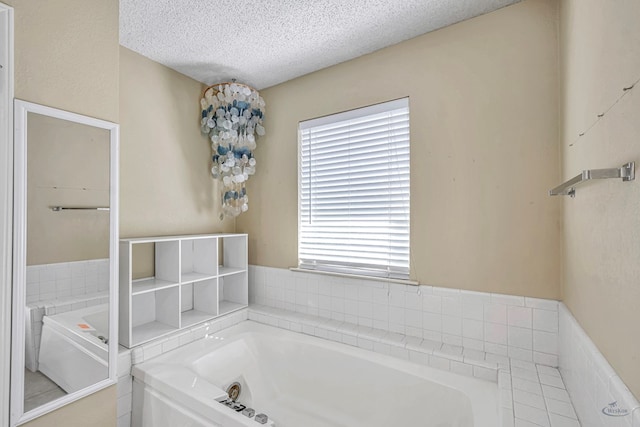 bathroom featuring a bathtub and a textured ceiling