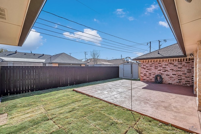 view of yard with a storage unit and a patio area