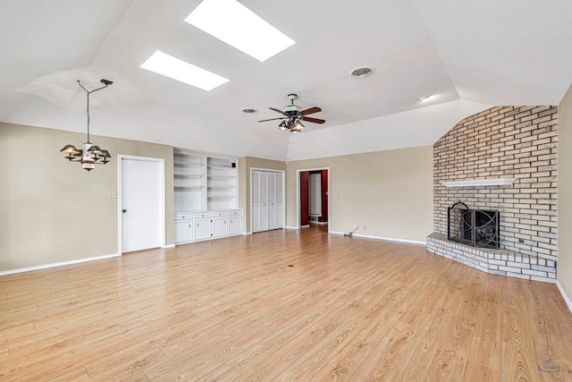 unfurnished living room featuring lofted ceiling, a fireplace, ceiling fan, and light hardwood / wood-style flooring