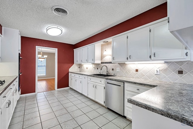 kitchen with light tile patterned flooring, sink, white cabinetry, tasteful backsplash, and stainless steel dishwasher