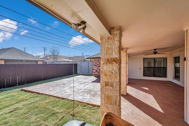 view of patio / terrace with ceiling fan and a storage unit