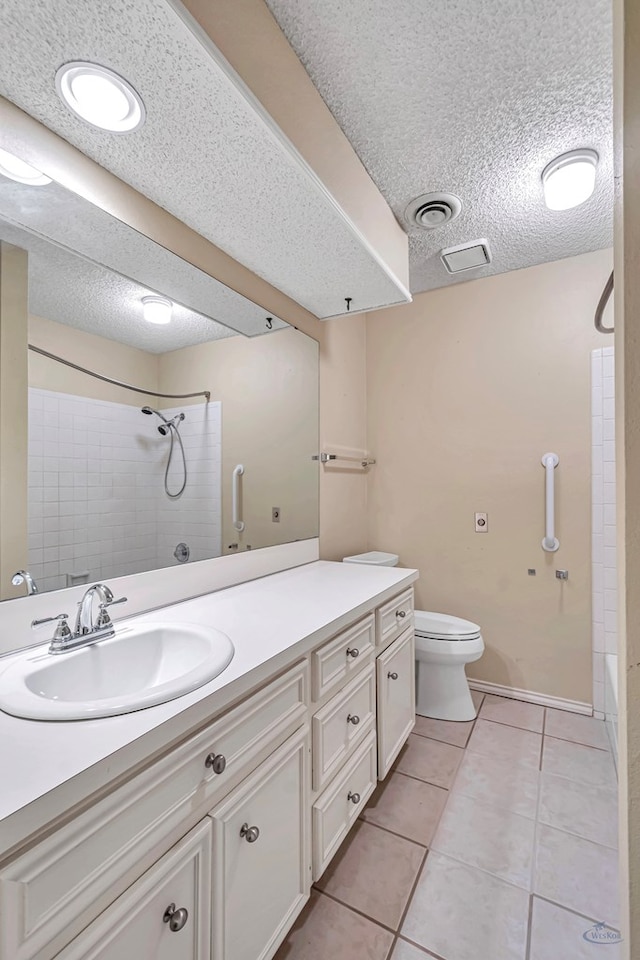 full bathroom with tile patterned floors, toilet, a textured ceiling, shower / tub combination, and vanity