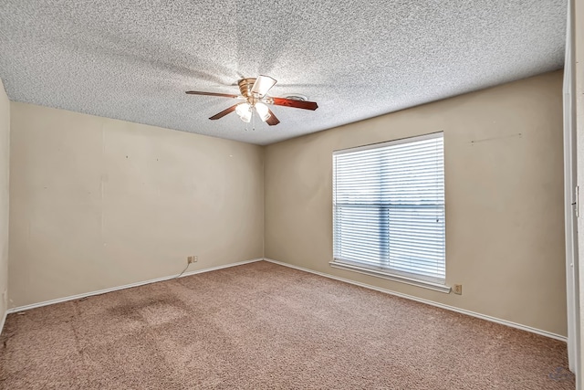 empty room featuring carpet flooring, a textured ceiling, and ceiling fan