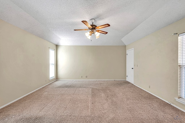 empty room with a textured ceiling, light colored carpet, and ceiling fan