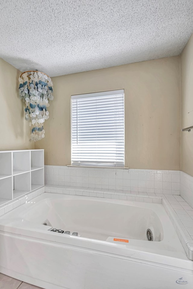 bathroom with a bathtub and a textured ceiling