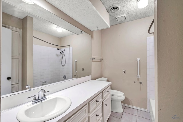 full bathroom with tiled shower / bath combo, vanity, a textured ceiling, tile patterned floors, and toilet