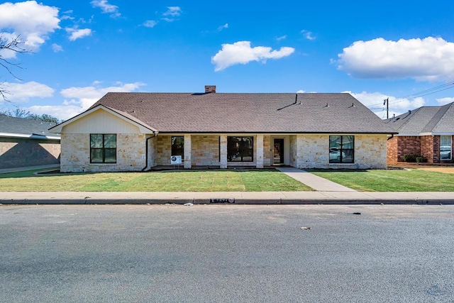 ranch-style home with a front lawn