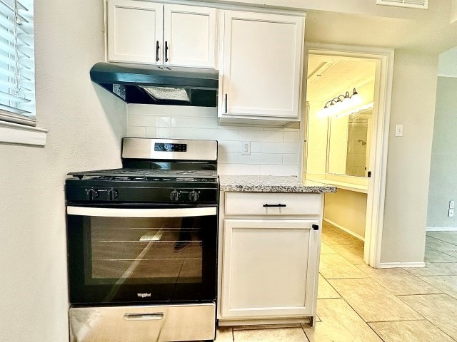 501 W Scharbauer Dr Unit 28, Midland, TX 79705 - kitchen with stainless steel gas range, white cabinets, under cabinet range hood, and tasteful backsplash