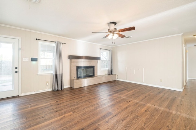 1702 Cessna Dr, Midland, TX 79705 - unfurnished living room with ornamental molding, ceiling fan, wood finished floors, a fireplace, and baseboards