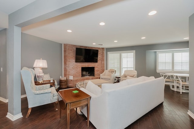 3300 Cambridge St, Odessa, TX 79761 - living area featuring dark wood-style floors, a brick fireplace, and recessed lighting