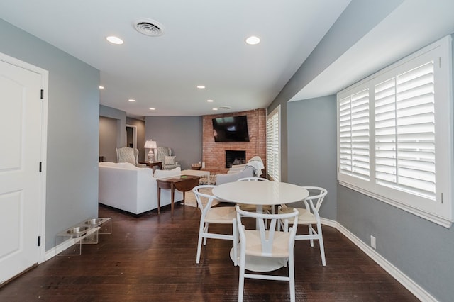 3300 Cambridge St, Odessa, TX 79761 - dining room with a brick fireplace, hardwood / wood-style flooring, and recessed lighting